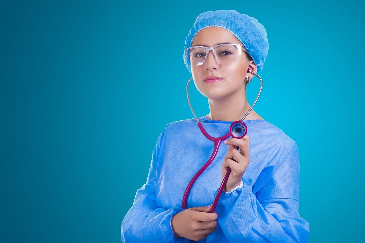 How Functional Medicine Is Empowering Women - Woman in Blue Scrubs Holding Stethoscope