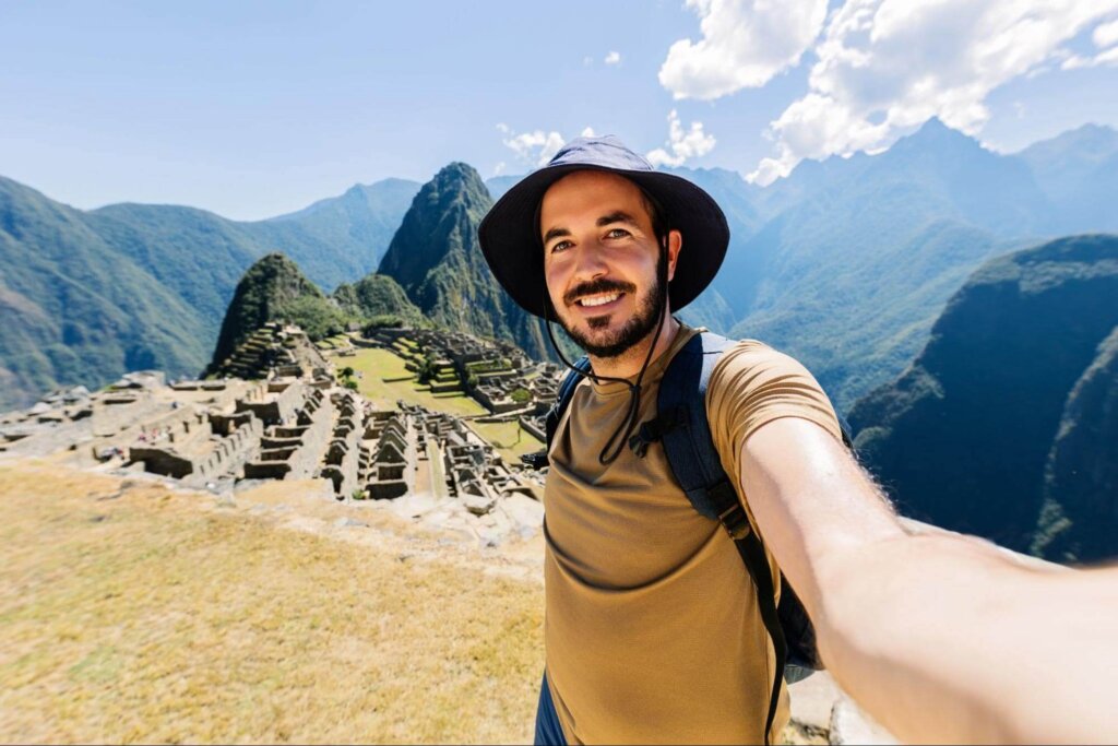 How to Travel Smart - Guy Wearing Hat Taking Selfie